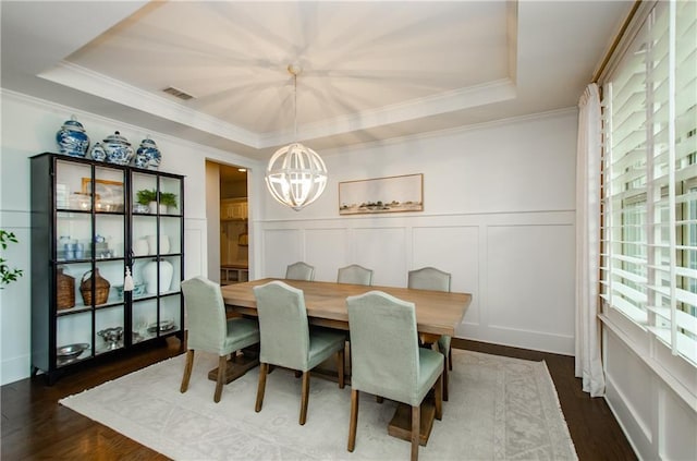 2535 Castlerock Ct, Cumming, GA 30041 - dining room with a tray ceiling, a chandelier, a decorative wall, dark wood-style flooring, and crown molding