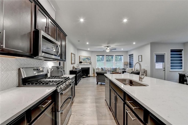 811 Pineberry Ct, Grayson, GA 30017 - kitchen featuring a sink, stainless steel appliances, recessed lighting, decorative backsplash, and light wood finished floors