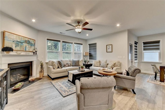 811 Pineberry Ct, Grayson, GA 30017 - living area with ceiling fan, light wood-type flooring, a glass covered fireplace, baseboards, and recessed lighting