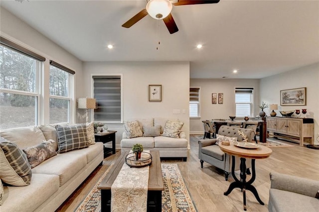 living area featuring baseboards, recessed lighting, plenty of natural light, and light wood-style floors