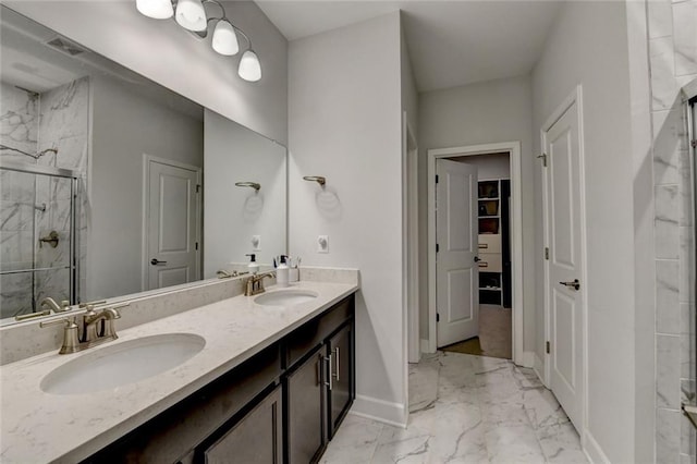 full bath featuring a stall shower, marble finish floor, visible vents, and a sink