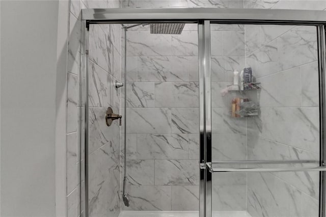 full bath featuring a marble finish shower