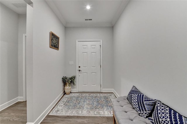 entryway featuring baseboards and wood finished floors