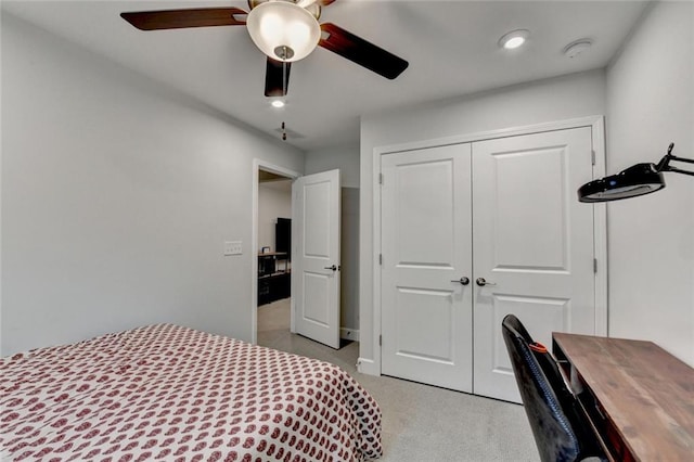 bedroom featuring light carpet, ceiling fan, a closet, and recessed lighting