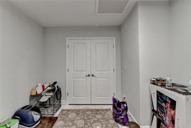 interior space with light tile patterned floors and baseboards