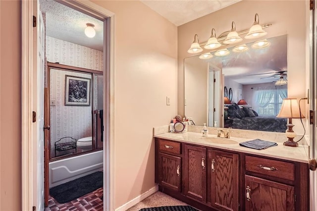 bathroom with a textured ceiling, vanity, shower / bath combination, and ceiling fan