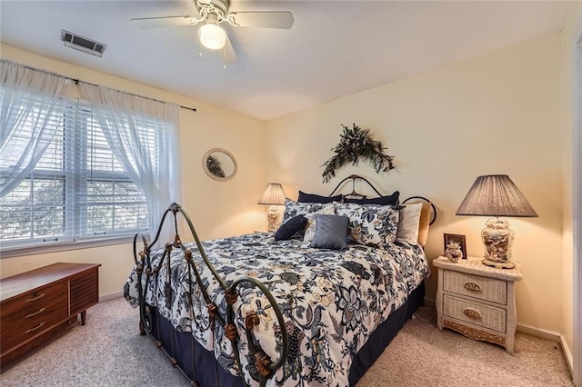 bedroom featuring ceiling fan and light carpet