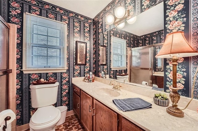 bathroom featuring toilet, vanity, and tile patterned floors