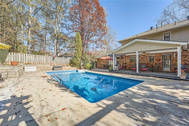 view of swimming pool with ceiling fan, a patio area, and a deck