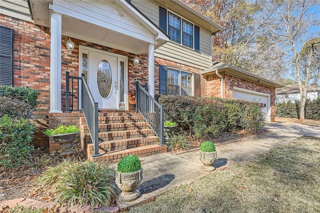 property entrance featuring brick siding and a garage