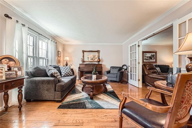 sitting room featuring crown molding, hardwood / wood-style floors, and french doors