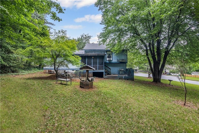 9760 Loblolly Ln, Roswell, GA 30075 - view of green lawn featuring a sunroom and a wooden deck
