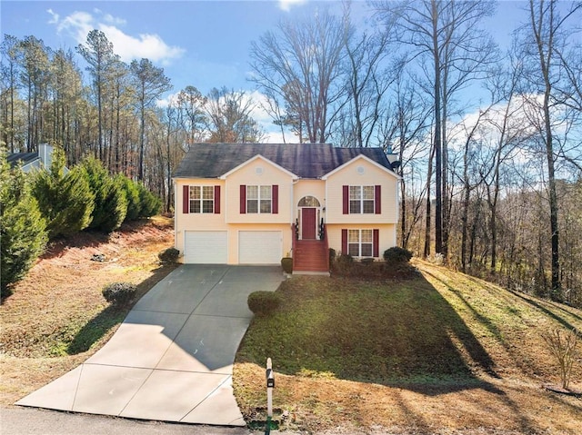 split foyer home featuring a garage and concrete driveway