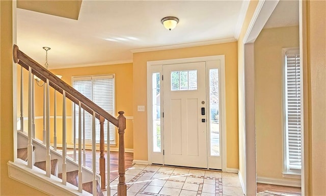 entrance foyer with crown molding and light tile patterned flooring