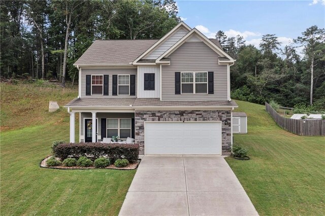 craftsman inspired home with a front yard and a garage