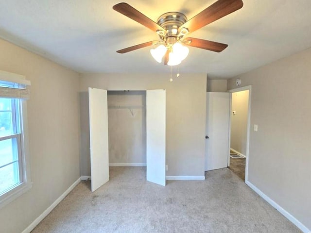 unfurnished bedroom with light carpet, a closet, and ceiling fan