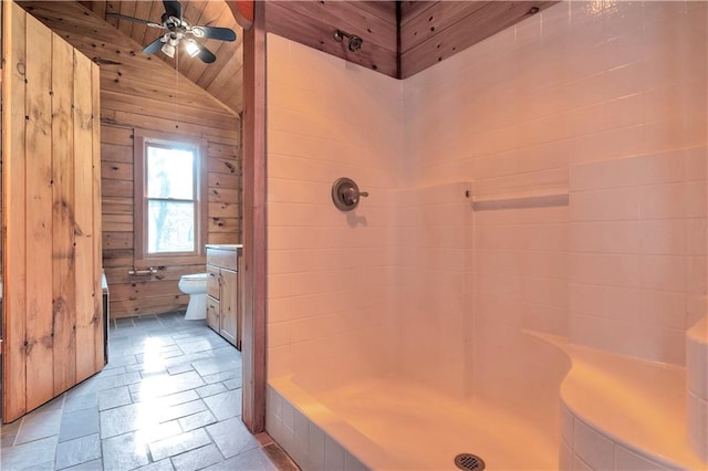 bathroom with wooden walls, ceiling fan, lofted ceiling, toilet, and wood ceiling