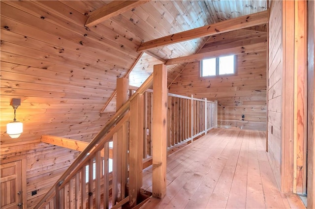 bonus room with wood walls, wooden ceiling, vaulted ceiling with beams, and light wood-type flooring