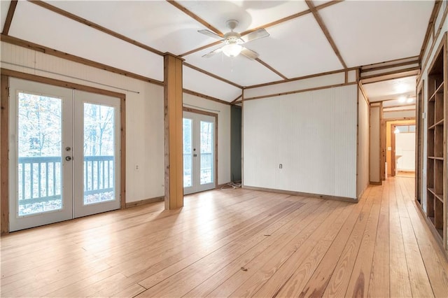 unfurnished room featuring plenty of natural light, light hardwood / wood-style floors, ceiling fan, and french doors