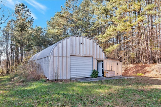 view of outdoor structure featuring a yard and a garage