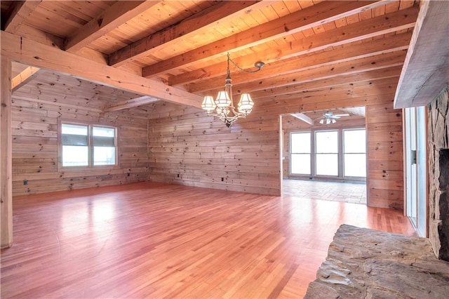 unfurnished room with wood walls, light hardwood / wood-style floors, wood ceiling, and ceiling fan with notable chandelier