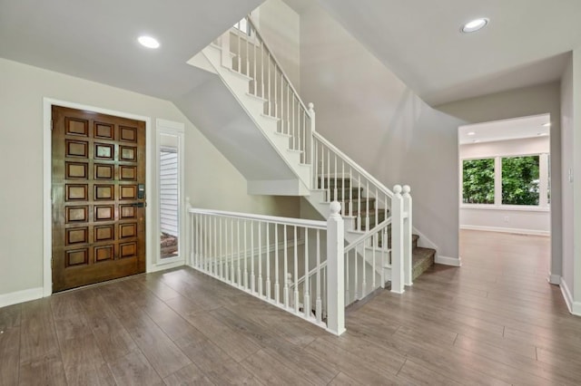 entrance foyer featuring wood finished floors, stairway, baseboards, and recessed lighting