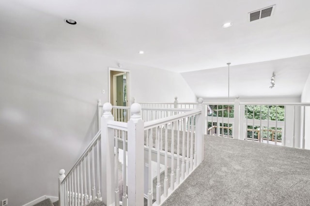 hall featuring carpet, lofted ceiling, recessed lighting, and an upstairs landing