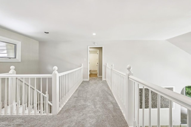 hallway featuring an upstairs landing, carpet flooring, and recessed lighting