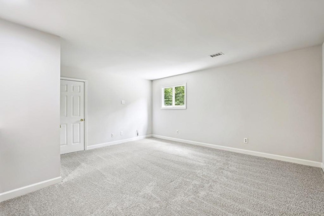 unfurnished room featuring baseboards and carpet