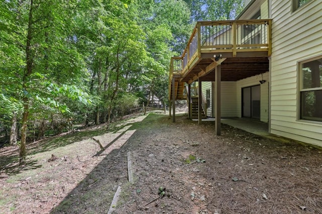 view of yard featuring stairway and a deck