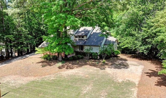 view of front facade with a chimney and dirt driveway