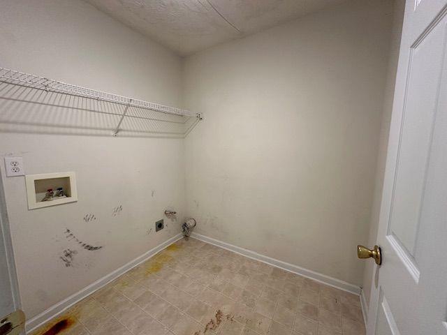 laundry room featuring laundry area, hookup for a washing machine, baseboards, and hookup for an electric dryer