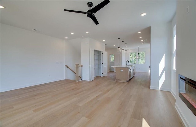 1919 Deco Dr, Kennesaw, GA 30144 - unfurnished living room with a ceiling fan, light wood-style flooring, and recessed lighting
