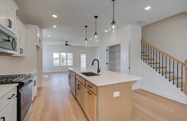 1919 Deco Dr, Kennesaw, GA 30144 - kitchen with stainless steel appliances, light wood-type flooring, a ceiling fan, recessed lighting, and light countertops