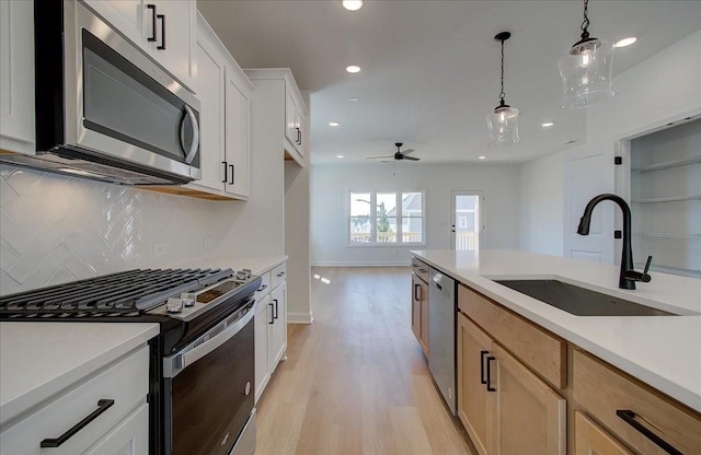 1919 Deco Dr, Kennesaw, GA 30144 - kitchen with stainless steel appliances, decorative backsplash, light wood-style flooring, recessed lighting, and light countertops