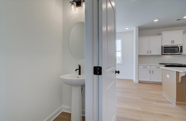 1919 Deco Dr, Kennesaw, GA 30144 - bathroom with wood finished floors and recessed lighting