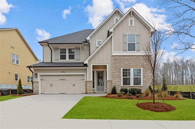 craftsman inspired home featuring a garage and a front lawn