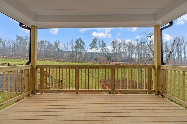 wooden deck featuring a rural view