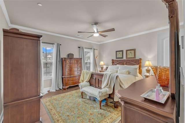 bedroom with hardwood / wood-style floors, crown molding, and ceiling fan