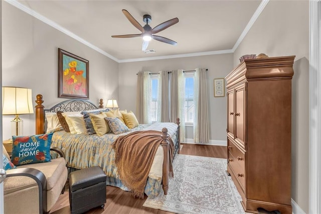 bedroom featuring hardwood / wood-style floors, crown molding, and ceiling fan