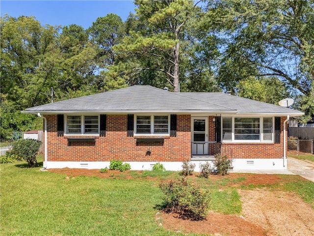 view of front facade with crawl space, brick siding, and a front lawn