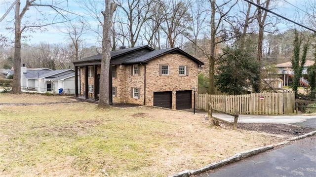 view of home's exterior with a garage and a lawn