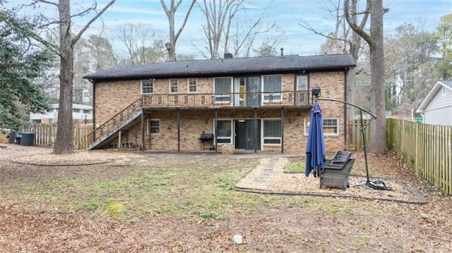 rear view of property featuring a wooden deck