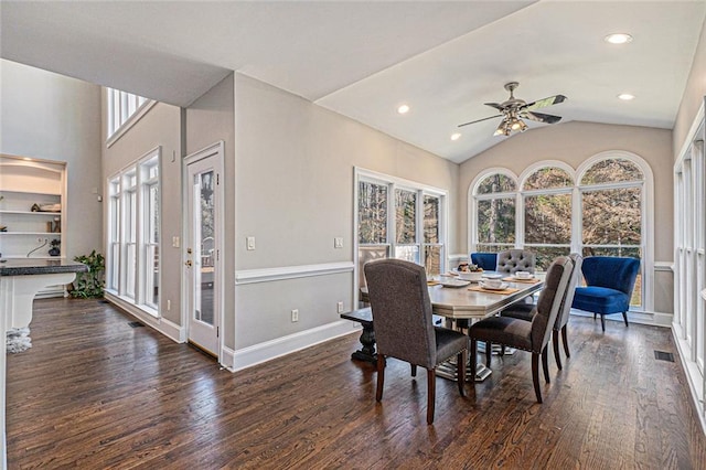 dining space featuring vaulted ceiling, visible vents, dark wood finished floors, and baseboards