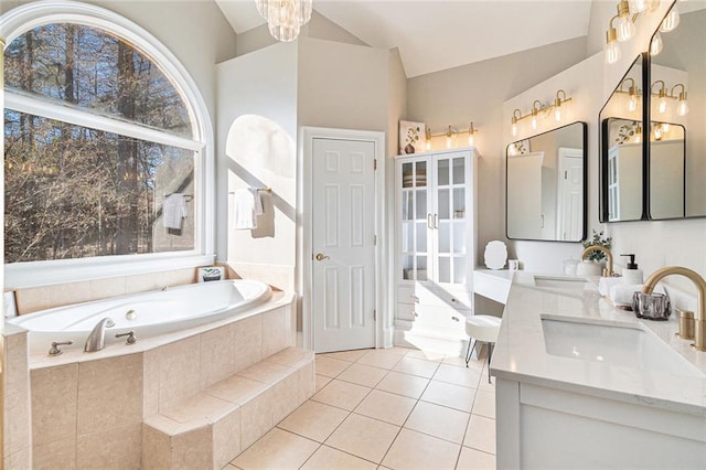 full bath featuring lofted ceiling, double vanity, tile patterned flooring, and a sink