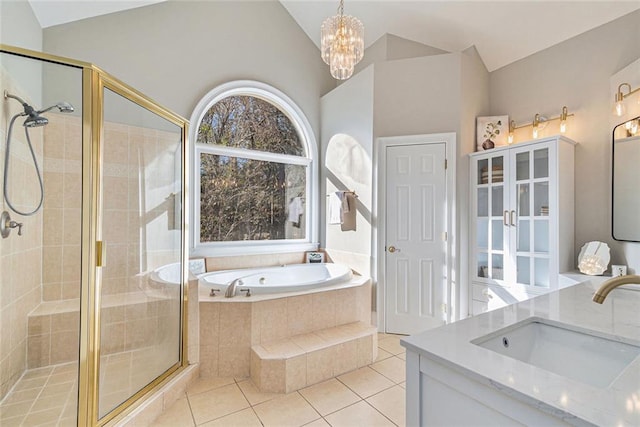 bathroom with lofted ceiling, a shower stall, vanity, and tile patterned floors