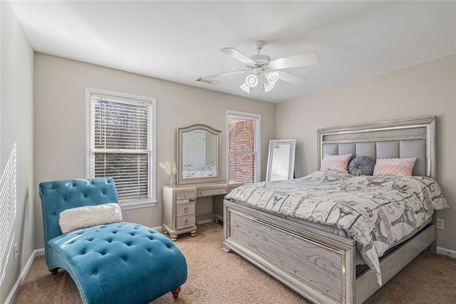 bedroom with baseboards, ceiling fan, visible vents, and light colored carpet