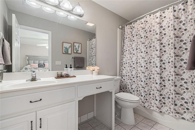 bathroom with toilet, ensuite bath, vanity, and tile patterned floors