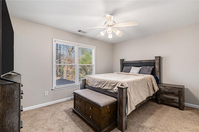 bedroom with a ceiling fan, visible vents, light carpet, and baseboards