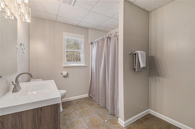 full bath featuring a paneled ceiling, visible vents, toilet, vanity, and baseboards